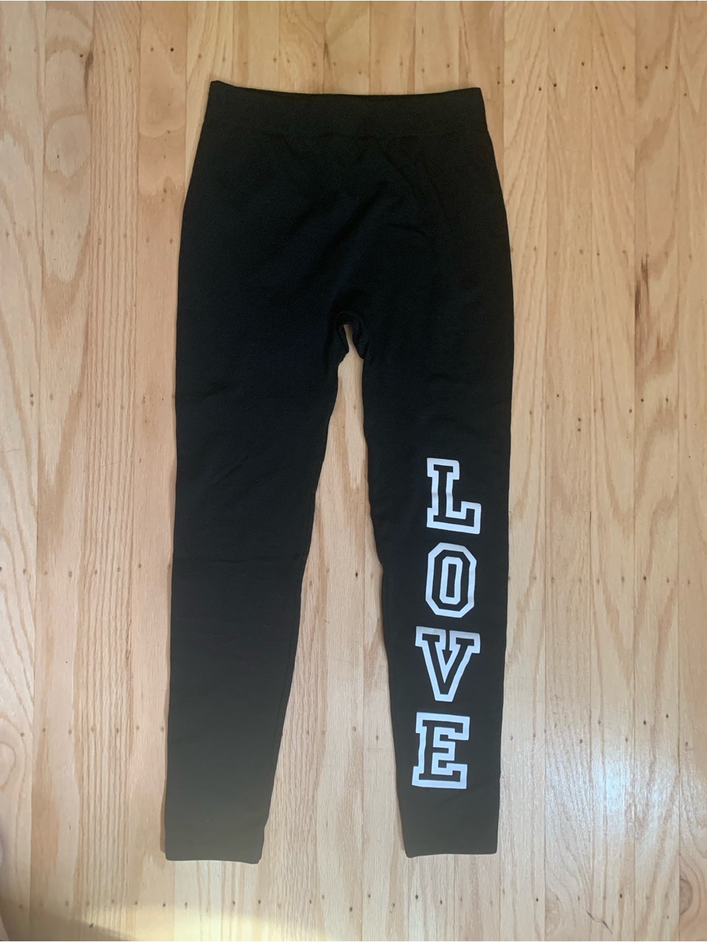 Bobbie Brooks black leggings with white 'LOVE' text on the right leg